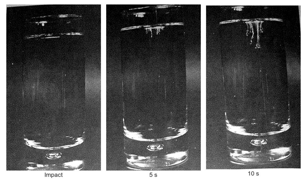 Three shot glasses of bleach showing a powder trail forming over ten seconds
