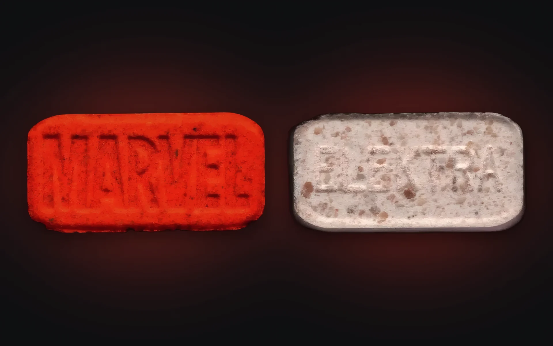 Red Marvel MDMA pill photographed from both sides, MARVEL logo on one face and ELEKTRA on the other