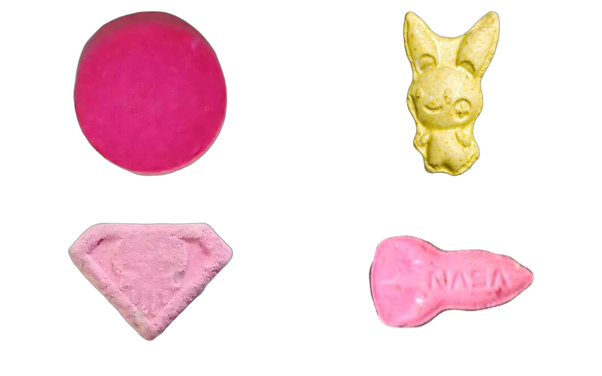 Four small pressed pills sold as 2C-B, three of them pink and one yellow