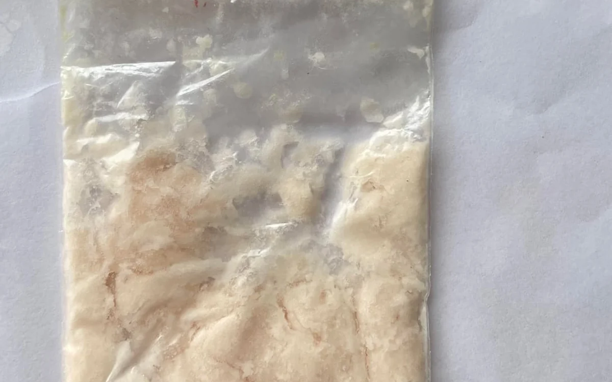 A bag of beige cream coloured amphetamine paste on white paper