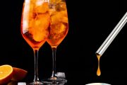 A drink test being used beside two orange cocktails